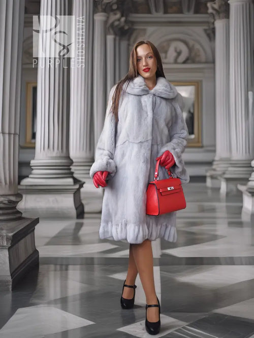 Light gray mink coat with petal-style collar and textured panels, mid-calf length, buttonless front.