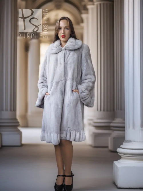Light gray mink coat with petal-style collar and full sleeves, knee-length with flared hem.