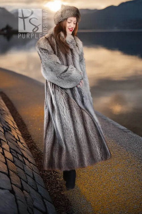 Gray raccoon fur coat with large hood and full sleeves; front three-quarter view