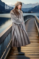 Long gray raccoon fur coat with oversized hood and fur cuffs; three-quarter view