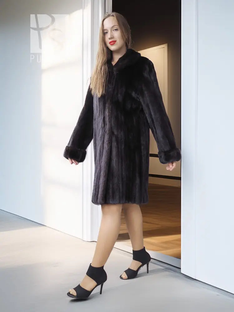 Reversible mink coat with dark fur texture, mid-length cut and curved button front.