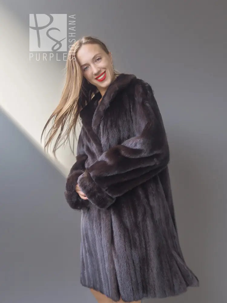 Reversible mink coat with plush dark fur collar and button front, angled front view.