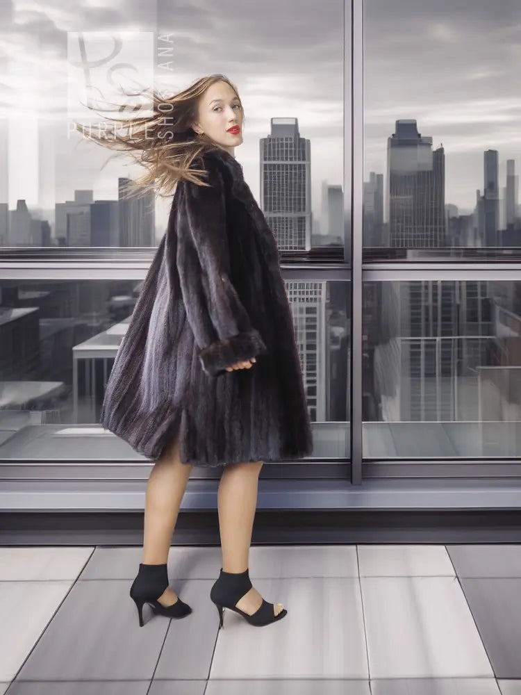 Reversible mink coat with dark fur body and long sleeves, full-length side stance.
