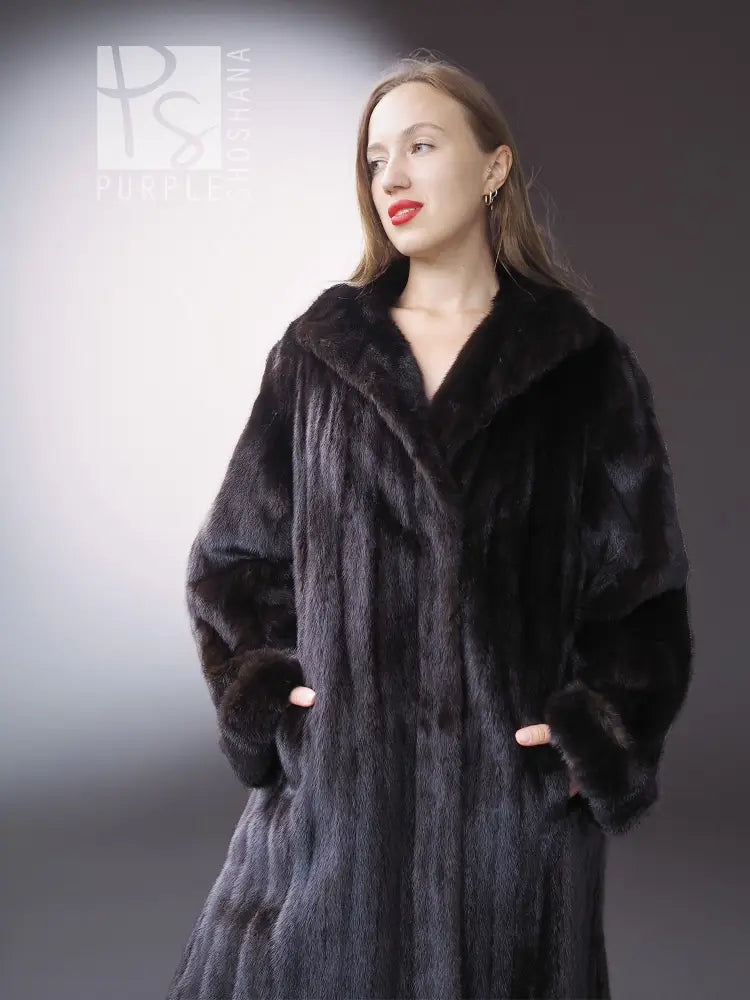 Reversible mink coat with dark fur finish and fur-trimmed cuffs, front close-up.