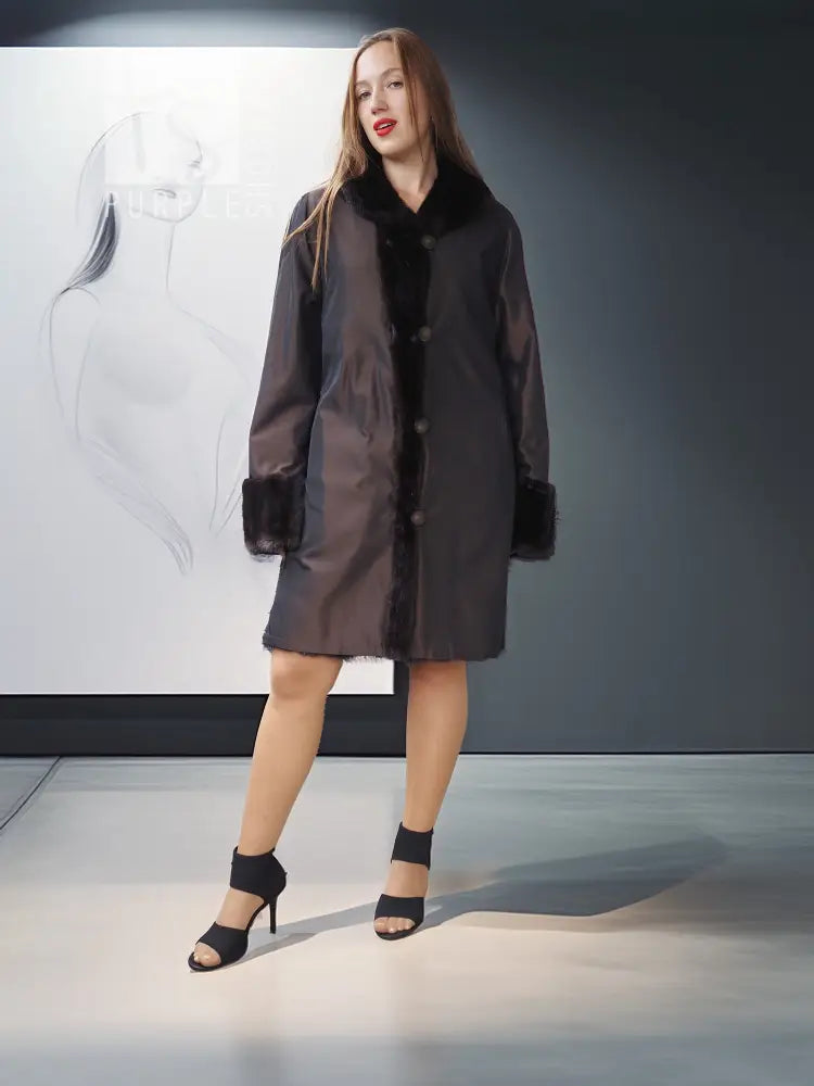 Reversible mink jacket with dark fur collar and cuffs, knee-length button-front design