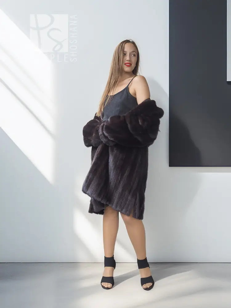 Reversible mink jacket with dark fur shoulder wrap and short button-front silhouette
