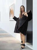 Reversible mink coat with dark fur texture, A-line silhouette and button front.
