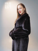 Reversible mink jacket with dark fur front, button placket, and wide padded sleeves