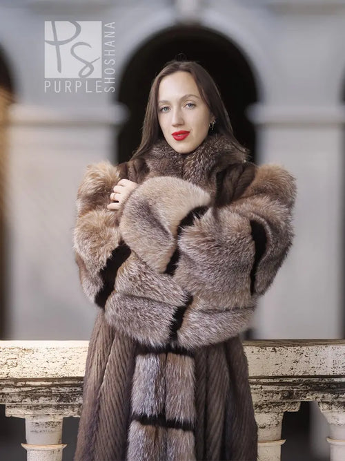 Front neckline detail of a striped mink fur coat with hood and wide, plush collar