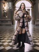 Full-length striped mink fur coat with hood and wide collar, styled over a black dress