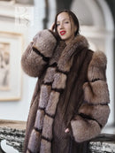 Close-up of striped mink fur coat with hood, wide collar, and plush textured trim