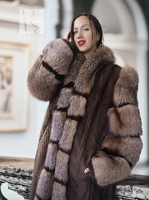 Close-up of striped mink fur coat with hood, wide collar, and plush textured trim