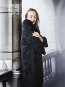 Dark lamb fur coat with thick fur collar, close front view with hand near collar
