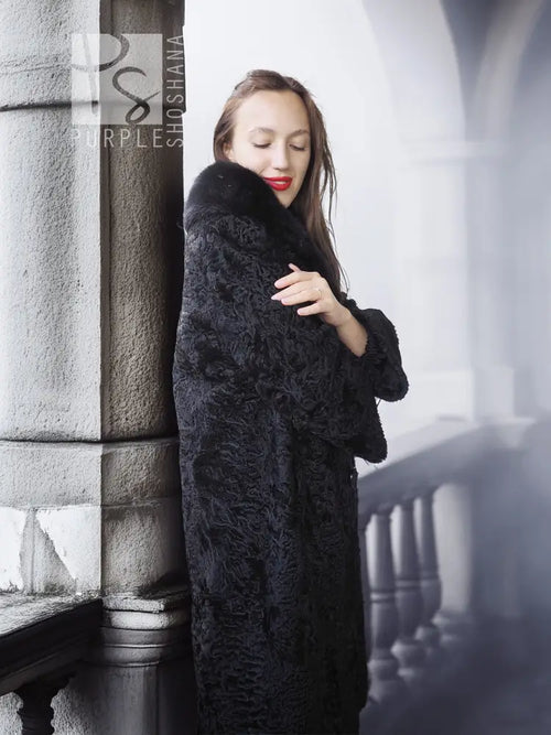 Dark lamb fur coat with thick fur collar, close front view with hand near collar