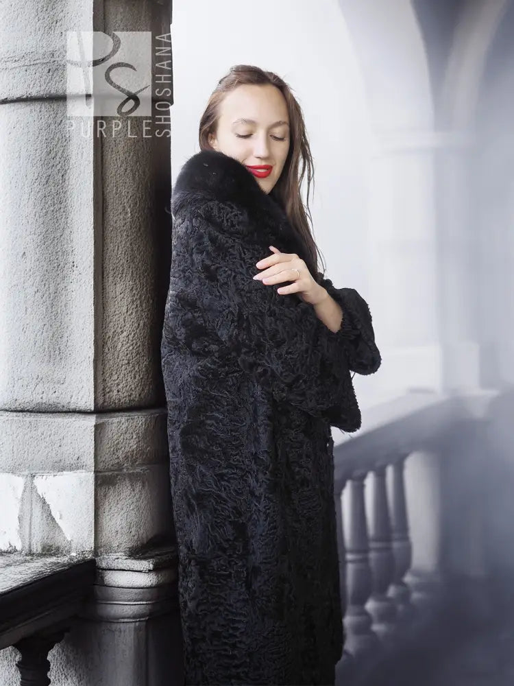 Dark lamb fur coat with thick fur collar, close front view with hand near collar