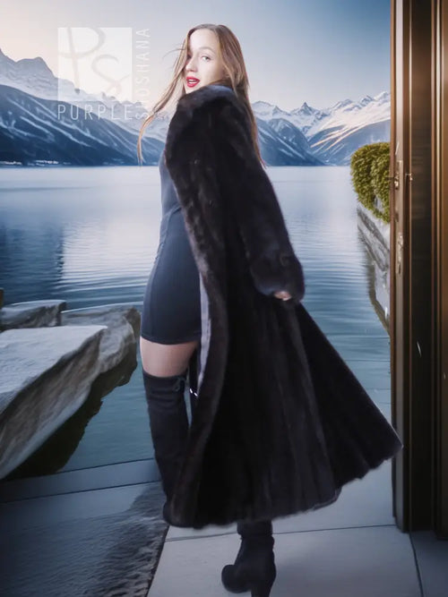 Black mink coat with flared sleeves over black dress and tall boots