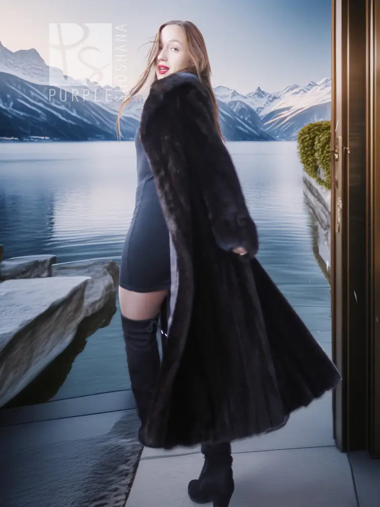Black mink coat with flared sleeves over black dress and tall boots