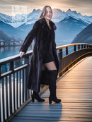 Black mink long coat with wide lapel and belted-like waistline, paired with beret