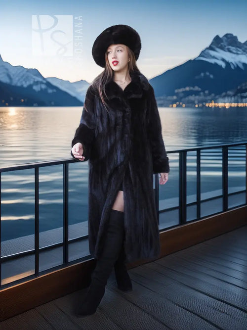 Black mink coat ensemble with beret, long fur coat with open front, standing on a deck