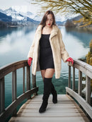 Light cream faux mink fur coat with red cuffs, worn open over a black bodycon dress