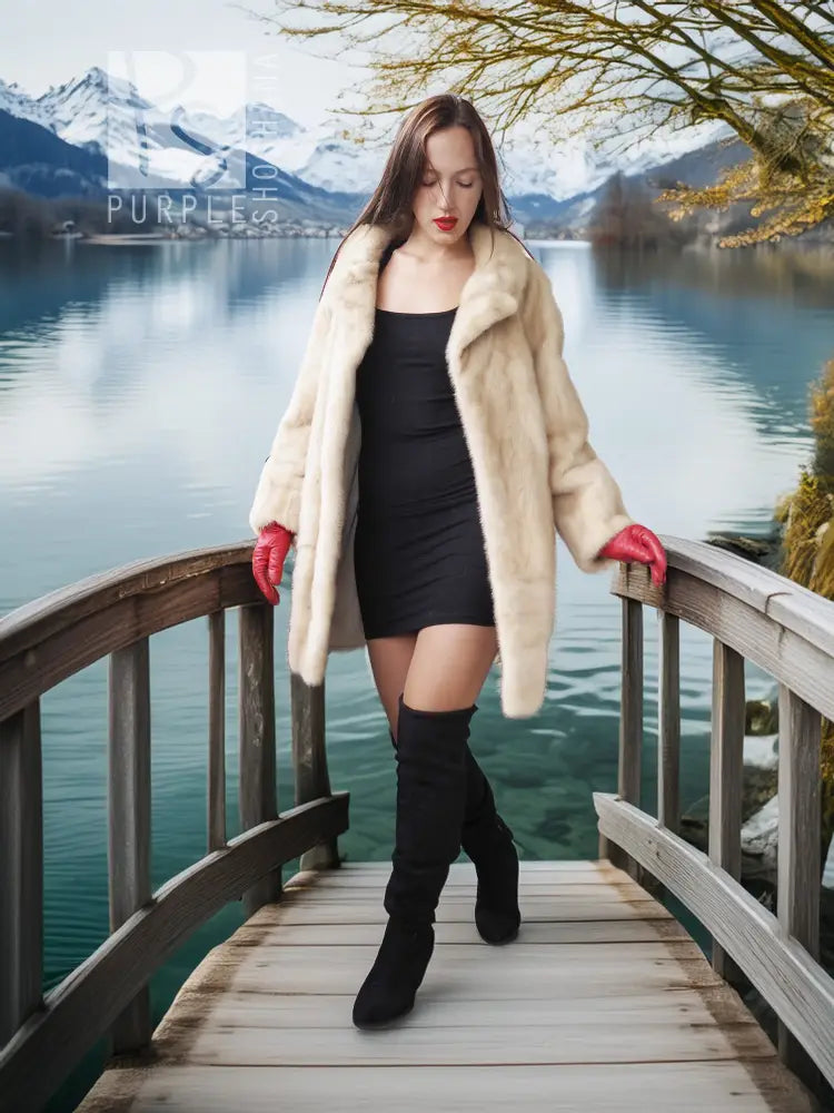 Light cream faux mink fur coat with red cuffs, worn open over a black bodycon dress
