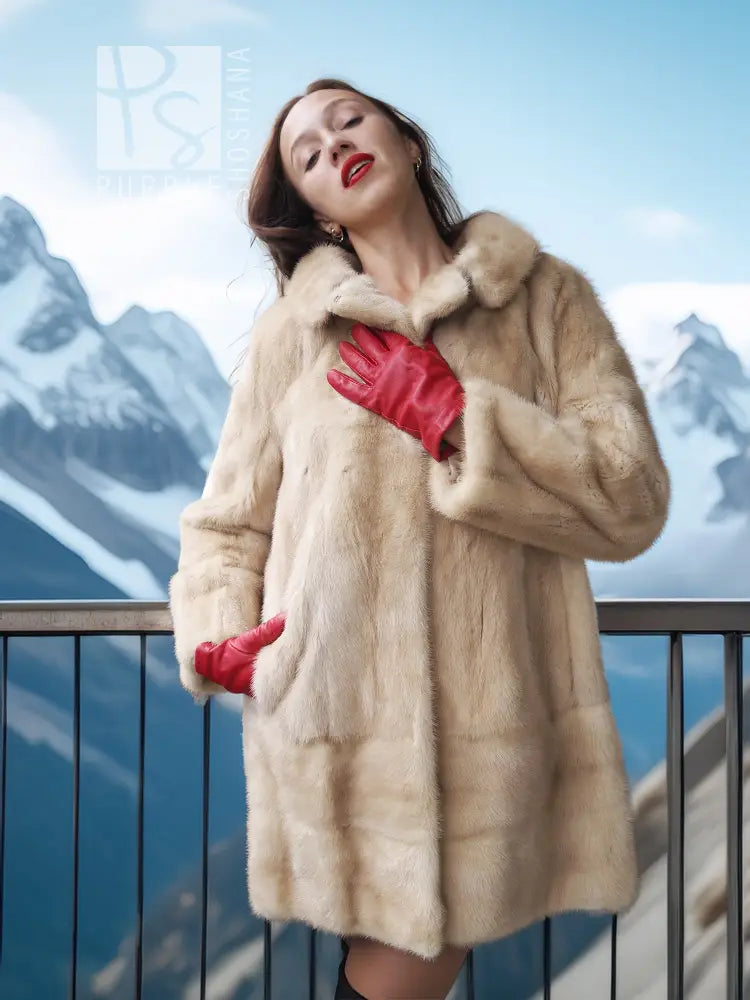 Cream faux mink fur coat with red inner cuffs, collar up and buttoned front