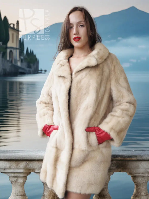 Faux mink fur coat in light cream with red cuff details and front-button closure