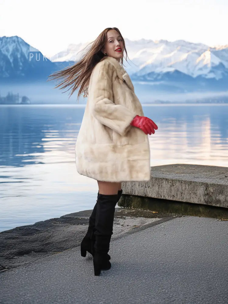 Light beige mink fur coat worn outdoors, red fingerless gloves and black boots