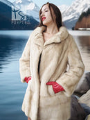 Cream mink fur coat with open front, red gloves, standing pose