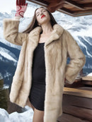 Light beige mink fur coat with hooded style and red gloves, close-up