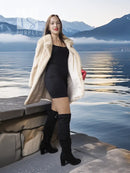 Light beige mink fur coat with open front over black mini dress
