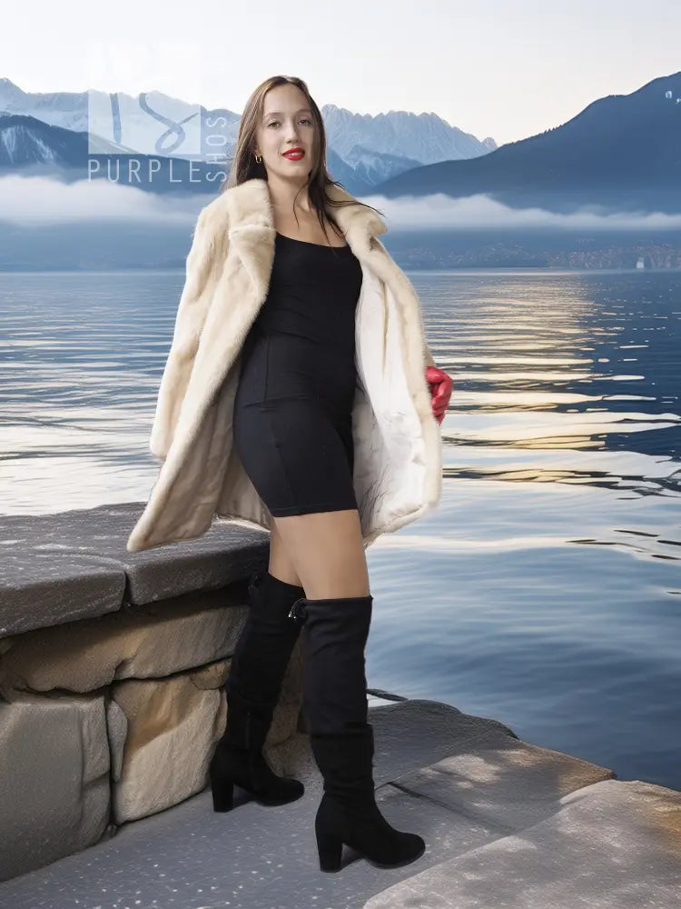 Light beige mink fur coat with open front over black mini dress