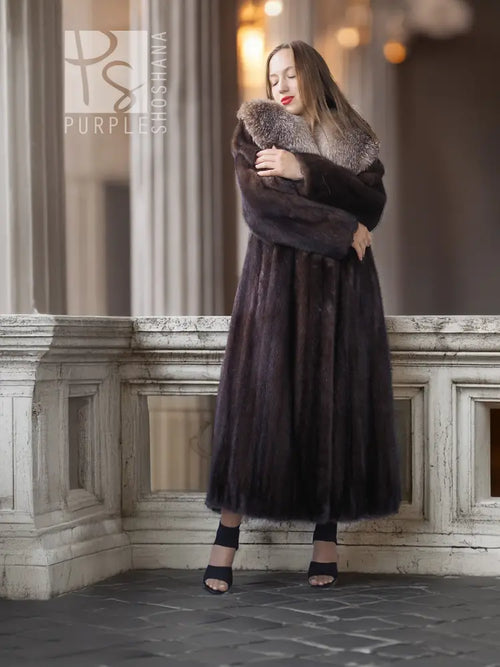 Vintage mink fur coat with pale fox-fur collar, holding coat, long sleeves.