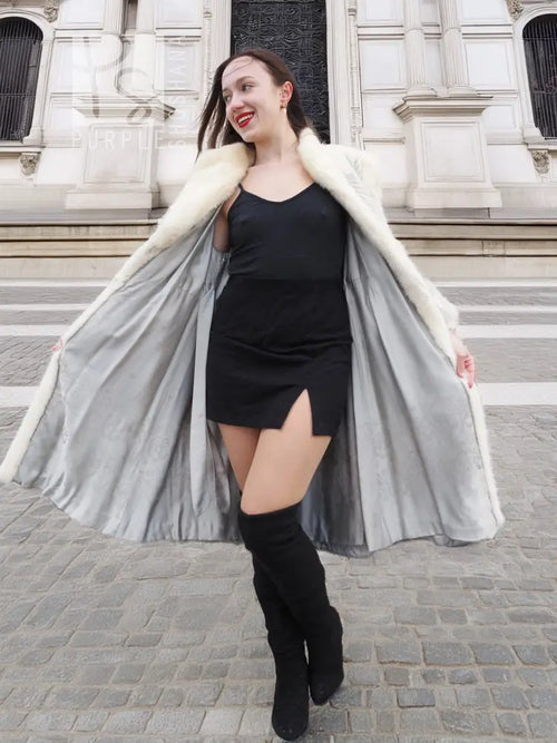 Cream faux-fur chevron coat with wide lapels and draped, flared open front