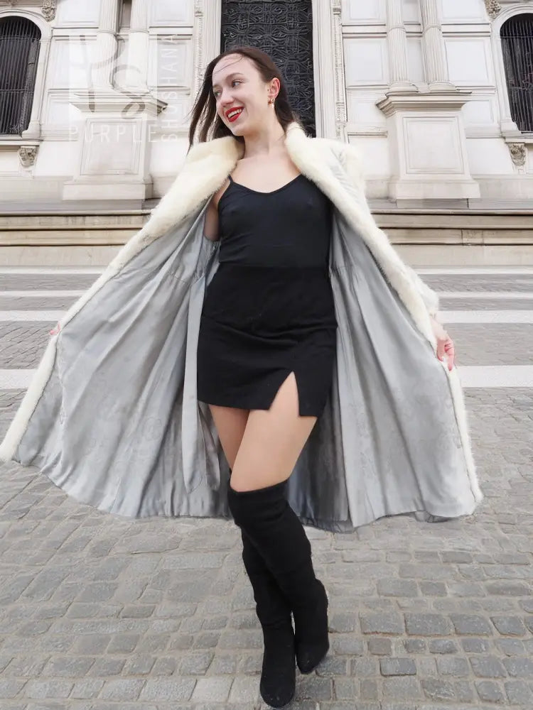 Cream faux-fur chevron coat with wide lapels and draped, flared open front
