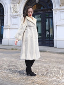 Cream chevron mink coat with plush fur collar and long, straight silhouette