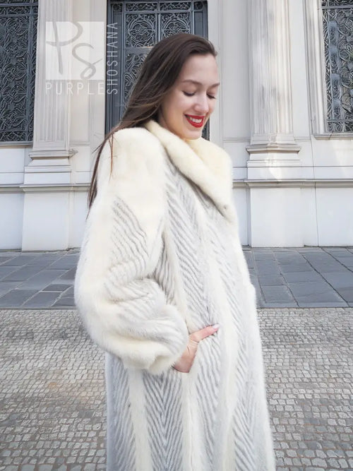 Full-length mink coat in light cream with chevron herringbone texture, side view