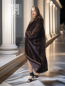 Mahogany brown mink fur coat, full length with relaxed shoulders and cuff detail.