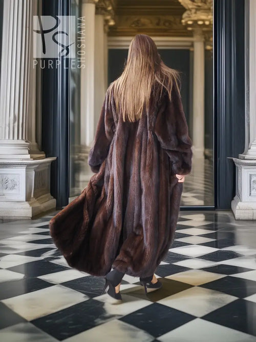 Long mink fur coat in dark brown, back view with flowing hem and voluminous sleeves