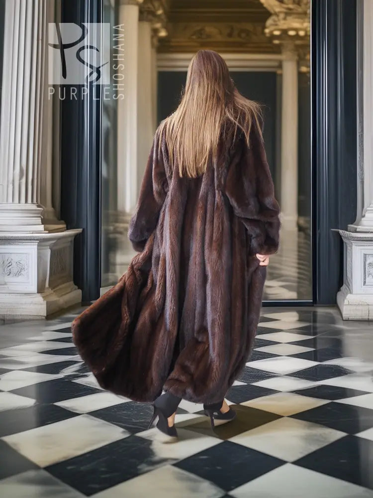 Long mink fur coat in dark brown, back view with flowing hem and voluminous sleeves