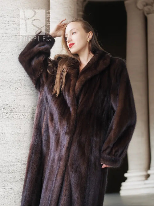 Mahogany mink fur coat on model, raised collar and textured fur surface.