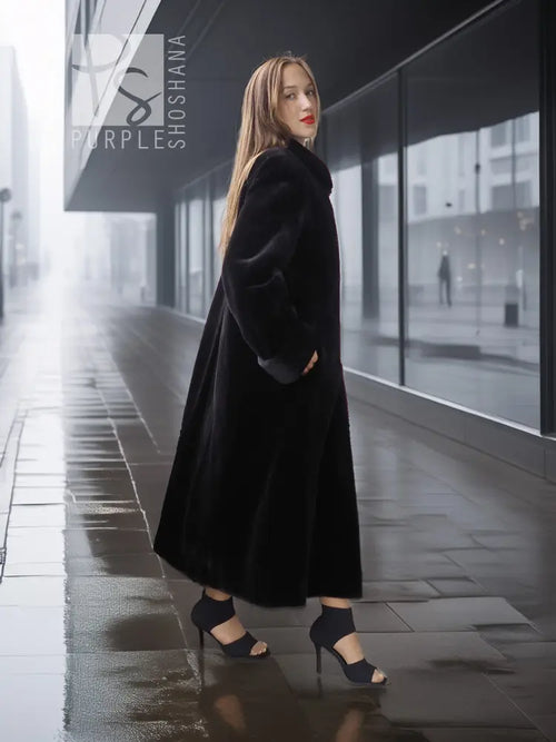 Reversible sheared mink coat in dark black with button-front and standing collar, side walking pose.
