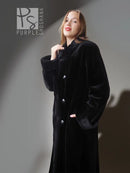 Reversible sheared mink coat in dark black with button-front and standing collar, close-up.
