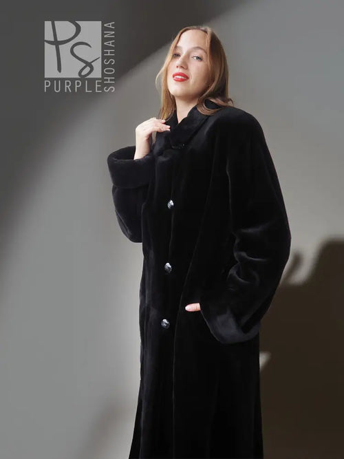 Reversible sheared mink coat in dark black with button-front and standing collar, close-up.