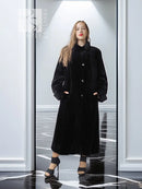 Reversible sheared mink coat in dark black with button-front and standing collar, full length.