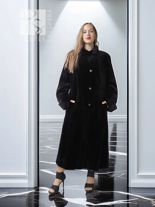 Reversible sheared mink coat in dark black with button-front and standing collar, full length.