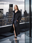 Black mink coat with long length and open front, side slit at hem