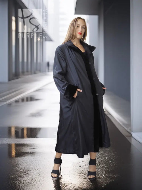 Black mink coat with open front and button details, long hem with side opening