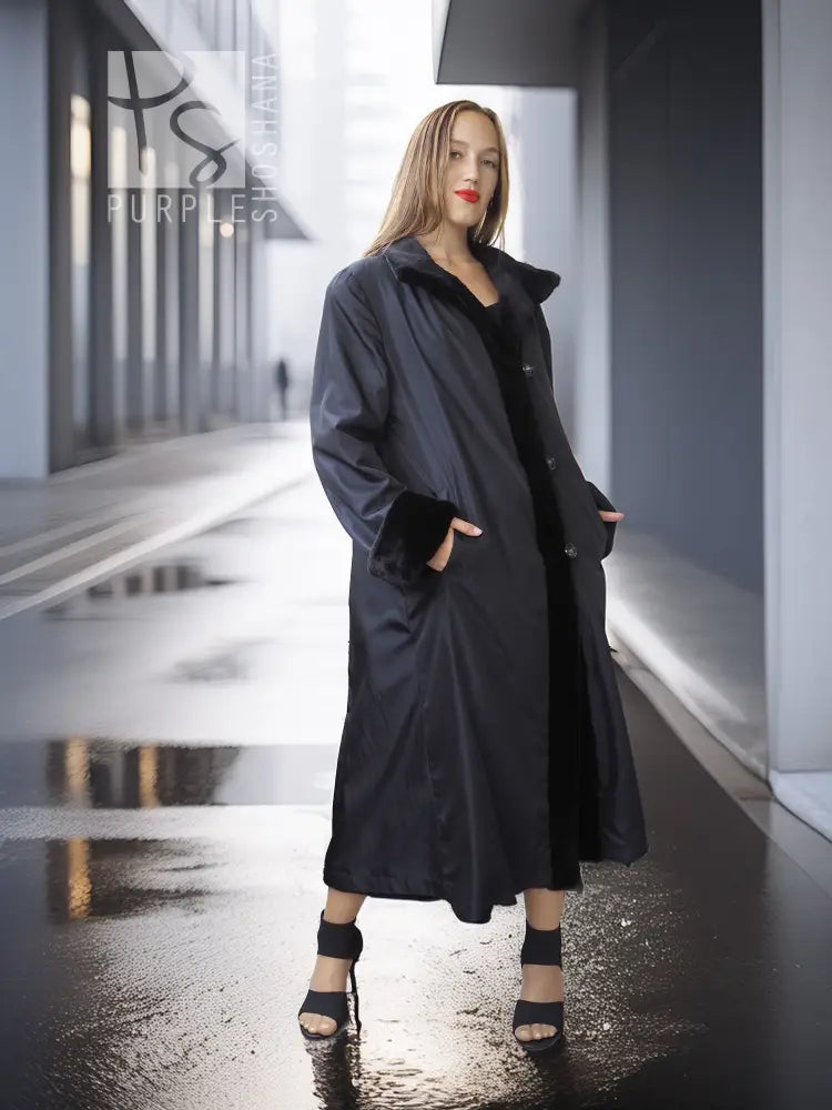 Black mink coat with open front and button details, long hem with side opening