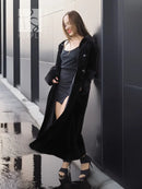 Black mink coat with open front and side slit, draped long hem